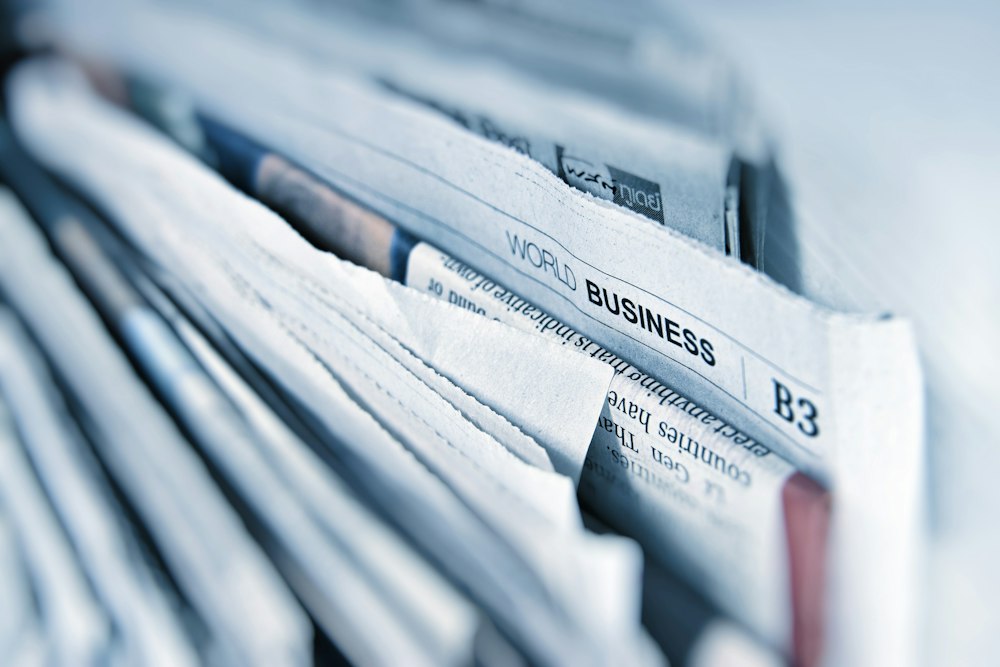 A stack of folded business newspapers